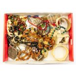 A collection of vintage costume jewellery including faceted glass bead necklaces, bangles, one horn,