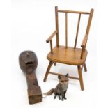 A carved wooden ventriloquist head; an apprentice piece chair; and a cold painted bronze fox,