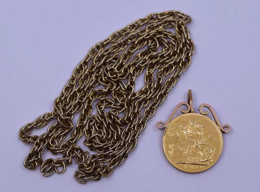 A gold sovereign mounted on yellow metal chain