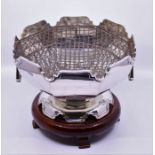 A George V silver octagonal Monteith or Rose Bowl, with wavy shaped rim and with two drop handles,