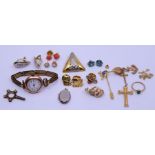 A collection of 9ct gold items to include charms, corpus, yellow metal mounted shell, opal