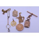 A collection of gold and yellow metal items including charms