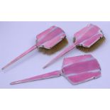 A silver Art Deco dressing set, finished in pink guilouche enamel