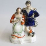 A Staffordshire figure of a lady playing a musical instrument with a man standing with his arm