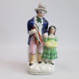 A Staffordshire Alpha factory figure of a musician with a young girl Circa: 1847 Size: 21cm H