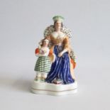 A Staffordshire figure of Queen Victoria with Princess Royal Pugh A figure 54 Circa: 1845 Size: 18cm