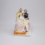 A Staffordshire figure of Queen Victoria and Prince Albert with child. Pugh A figure 24 Circa: