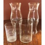 Two glass vases 24cm & 21cm H; together with two shaped glass cylinders 41cm H (4)