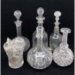 Five cut glass decanters, with a vase and an assortment of stoppers (qty)