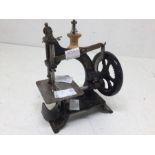 A miniature cast early 20th Century children's sewing machine, no makers name present, with