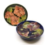 A Moorcroft pottery Hibiscus green ground bowl together with a Moorcroft pottery bowl