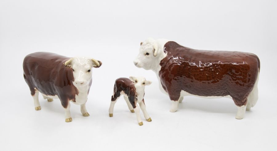 Three Beswick figures of a bull, cow and calf no chips or cracks
