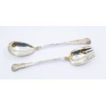 A pair of Victorian Irish King's pattern silver servers, each handle engraved with a crest,