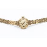 A ladies 9ct gold Omega wristwatch, circa 1960's, comprising a round champagne dial, applied gold