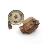 A carved and painted stone Egyptian head, a glazed pottery dish and a carved hardstone seal (3)