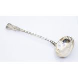 An early Victorian King's pattern silver soup ladle, the handle engraved with a crest, hallmarked by