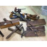 A collection of vintage wood work tools including planes etc