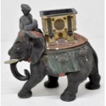 An early 20th Century tobacco jar detailing an Indian man riding and elephant along with match