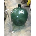 A 19th Century style large green glass carbuoy together with a large trumpet clear glass shaped vase