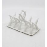 Shooting interest; A Continental porcelain toast rack with rifles