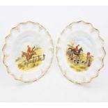 A pair of Royal Crown Derby plates with hunting scene designs