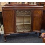 An early 20th Century display cabinet having one glazed and two inlaid doors, on ball and claw feet,