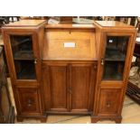 An early 20th Century treasurer/secretary's desk, in oak, comprising a central desk section and side