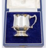 A modern Celtic Revival silver christening cup, urn shaped plain body with applied lower section