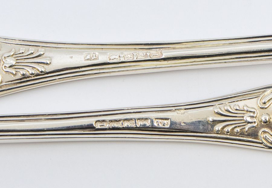 A pair of Victorian Irish King's pattern silver servers, each handle engraved with a crest, - Image 2 of 2