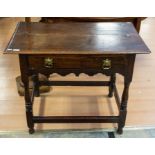 A late 17th Century oak lowboy, having single drawer, turned legs and sculpted fascia, played with