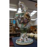 A late 19th Century German porcelain vase, decorated with flower, shells, foliage and puttis, on