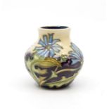 Small Moorcroft posy vase, 1999, beige and purple ground, wild flower detail