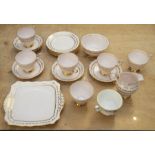 A Tuscan china tea set, circa 1930's including six cups and saucers, milk jug, bowl and plate
