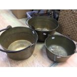 A set of three brass jam pans