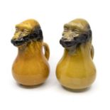 A pair of ceramic monkey jugs