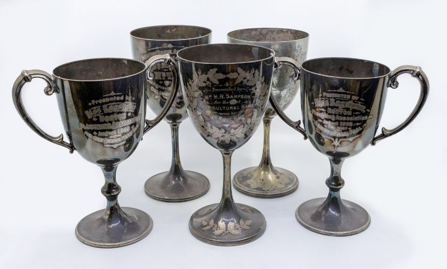 A collection of five Edwardian large silver plated presentation goblets, each with engraved