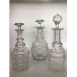 Three clear glass decanters to include a 4 neck ring example with large hobnail cut body and star