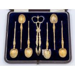 A set of six George V coronation silver gilt anointing teaspoons and matching sugar nippers with