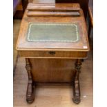 A 19th Century walnut Davenport, having green leather insert, dummy drawers to one side and four