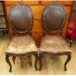 Two late 18th, early 19th Century round back Continental pair of chairs, carved backs, brown