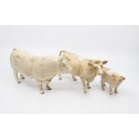 Three Beswick figures including a bull, cow and calf no chips or cracks