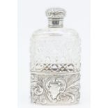 A Victorian silver mounted hob nail cut glass flask, the detachable base chased with flowers and