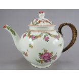 An eighteenth century Lowestoft hand-painted floral teapot and cover with make-do tinker handle,