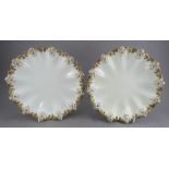 A pair of late nineteenth century Coalport moulded dessert plates in the shell-form with shell