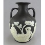 A late eighteenth century Wedgwood two colour jasper portland vase, c. 1780. It is decorated with