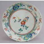 An eighteenth century Japanese Kakiemon large saucer dish decorated with flowers and blossom. 25