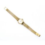 An 18k lady's Omega automatic wristwatch with date aperture, baton numerals and 18k  with paperwork,