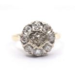 An 18ct diamond cluster ring, the centre stone star set with border of eight further diamonds, 4.2g