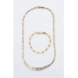 A 14k white and yellow gold necklace of stylised graduated pierced links with similar 14k gold