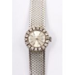 An 18ct white gold Jaeger LeCoultre lady's watch with diamond set bezel, baton numerals, gross